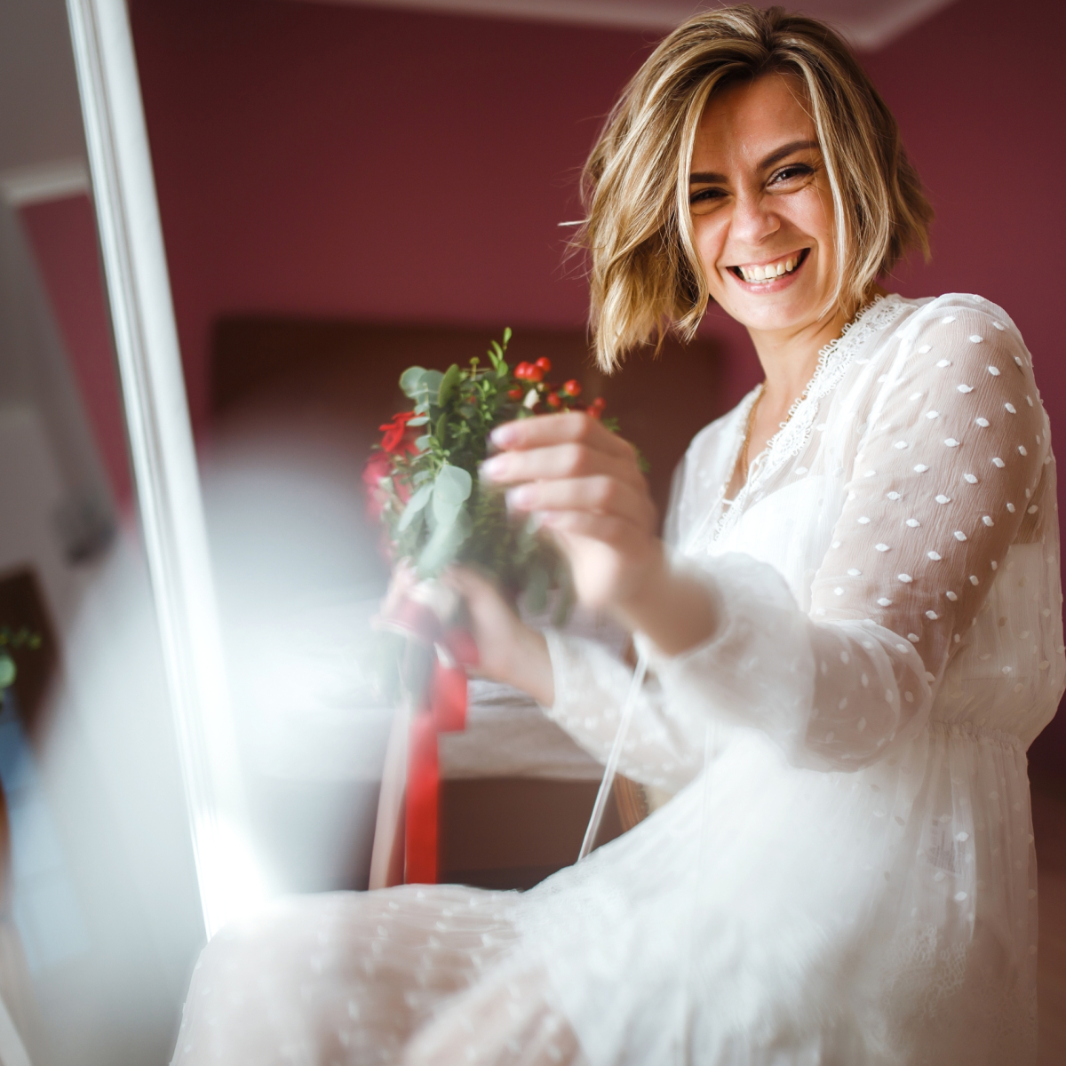 Beautiful bride with wedding flowers bouquet in white luxury dress is getting ready for wedding.